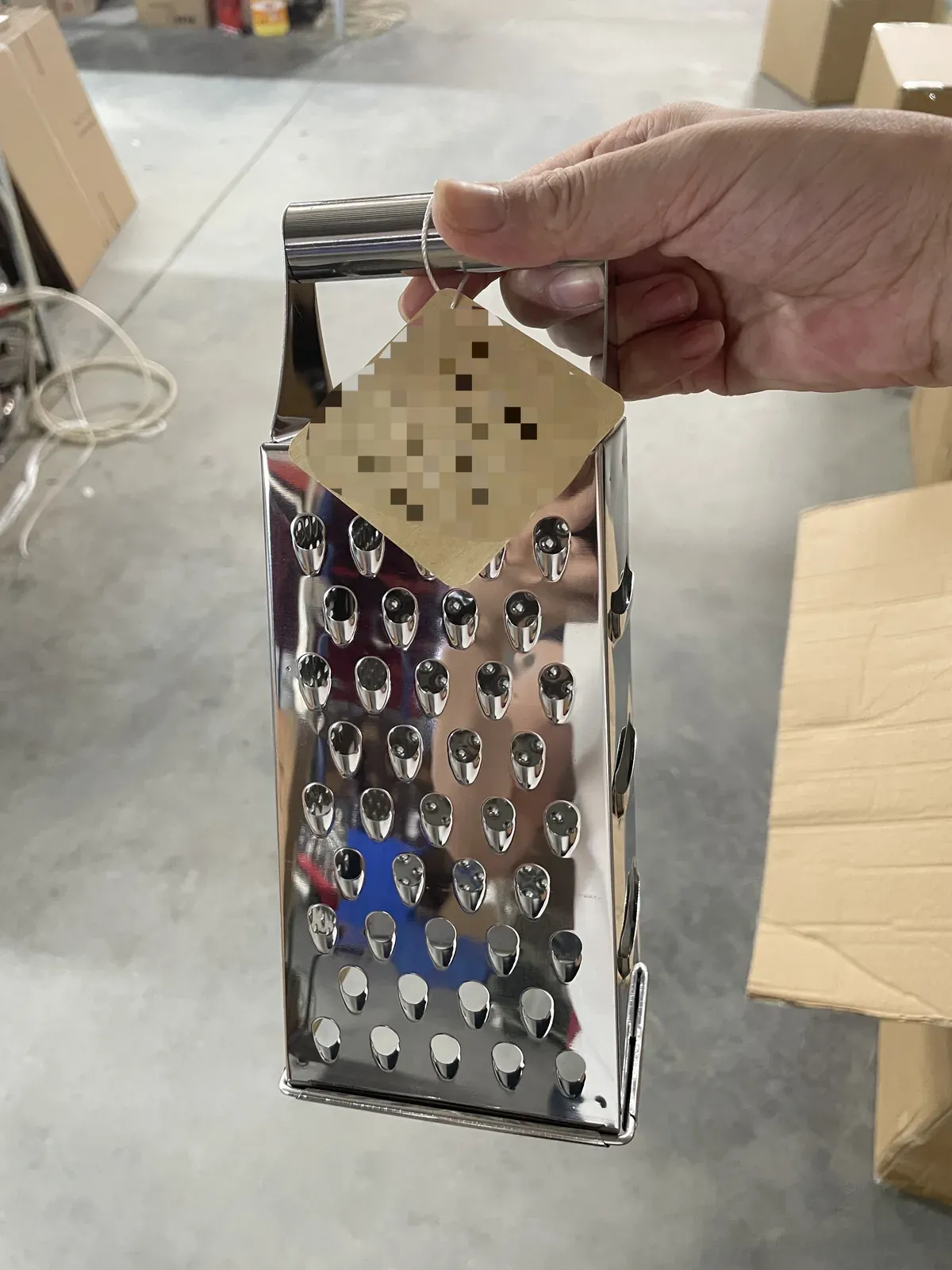 Customized hang tag attached to a stainless steel four-sided grater