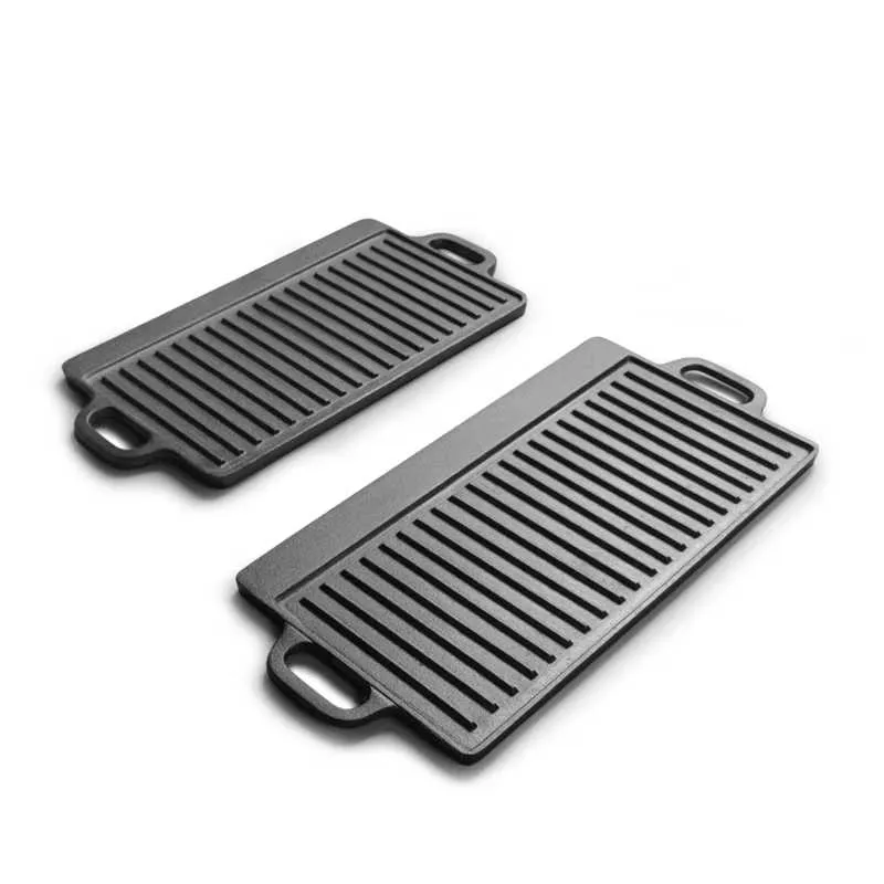 Two ribbed rectangular cast iron grill plates with integrated handles from the Wancomee cookware range