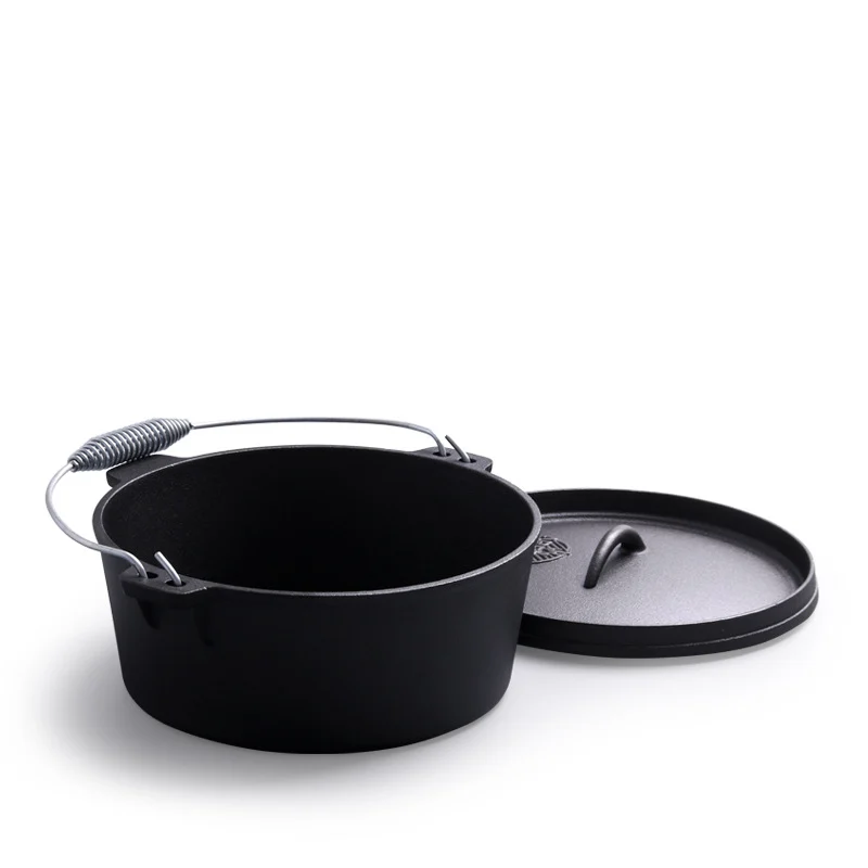 Cast iron camp Dutch oven with the lid set beside the pot